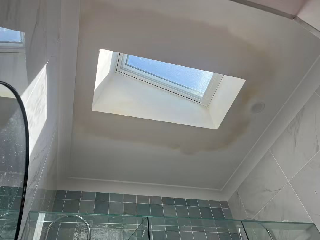 Skylight above a bathroom with green tiles