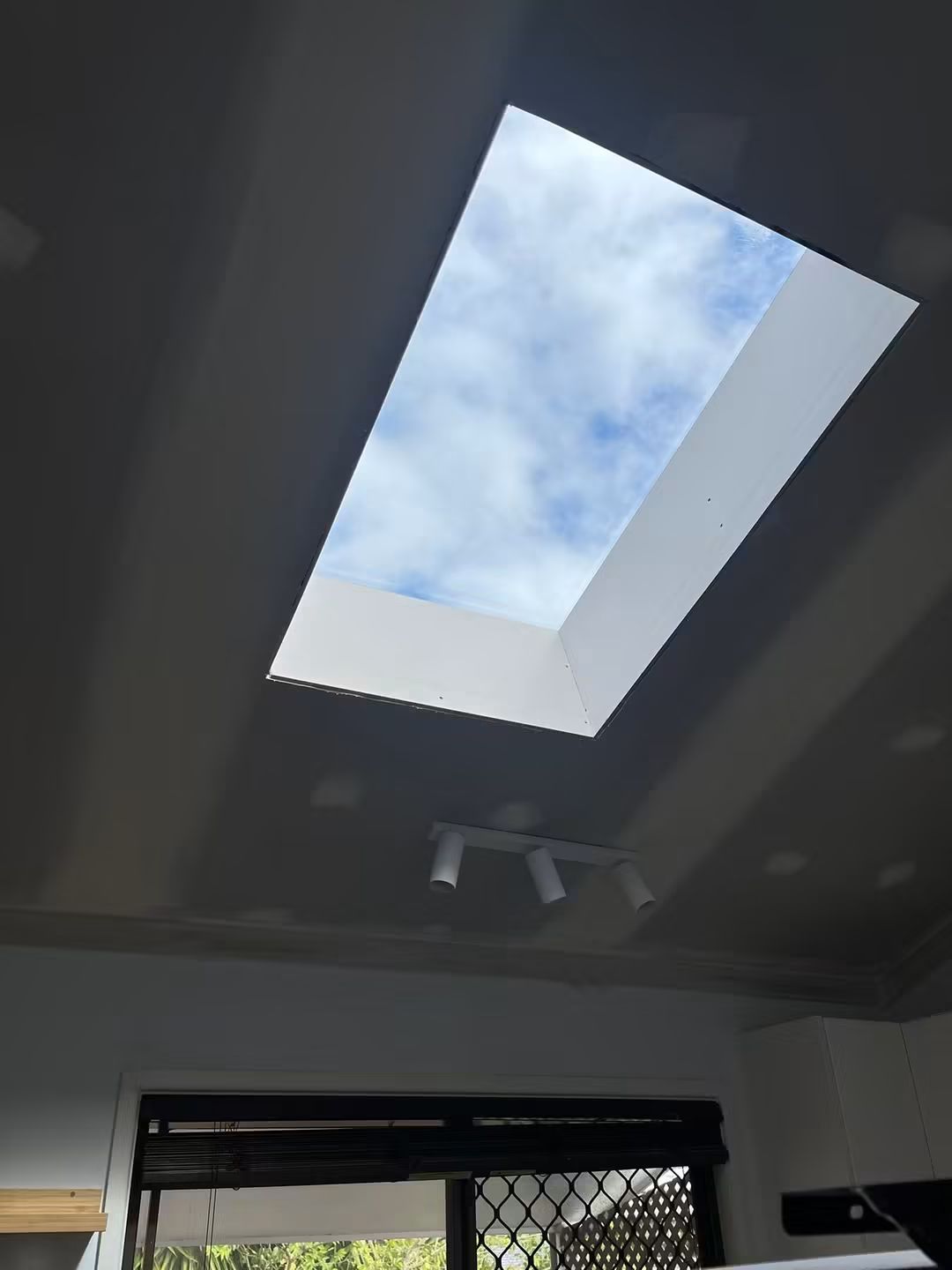 Skylight above a dark hallway ceiling