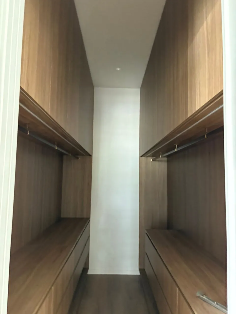 Walk-in robe with timber joinery lit from above