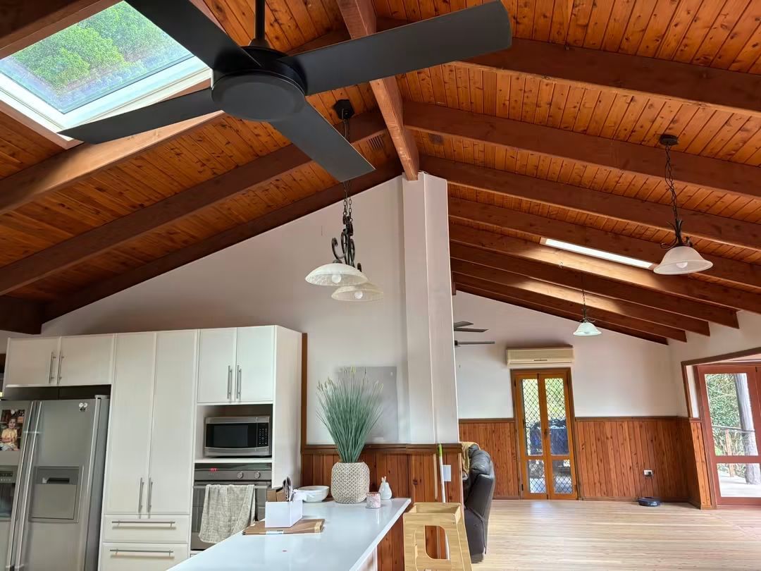 Two skylights in a raked timber cathedral ceiling above a kitchen