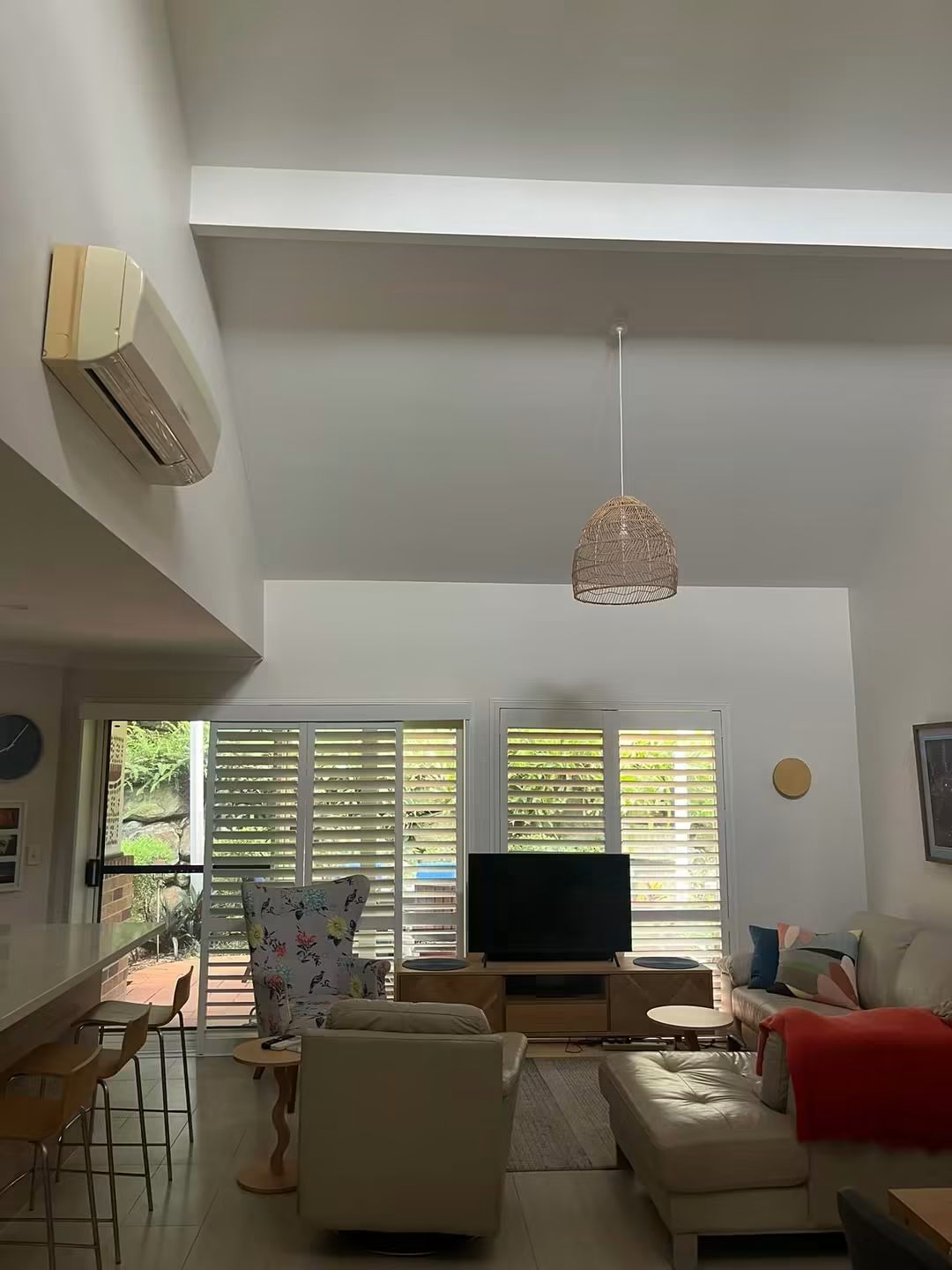 Living room with skylight and plantation shutters