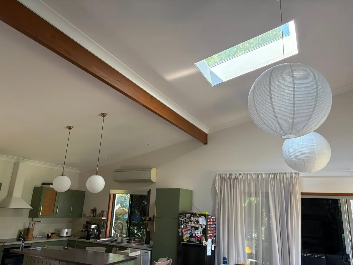 Skylight in a raked ceiling above a kitchen with paper lanterns