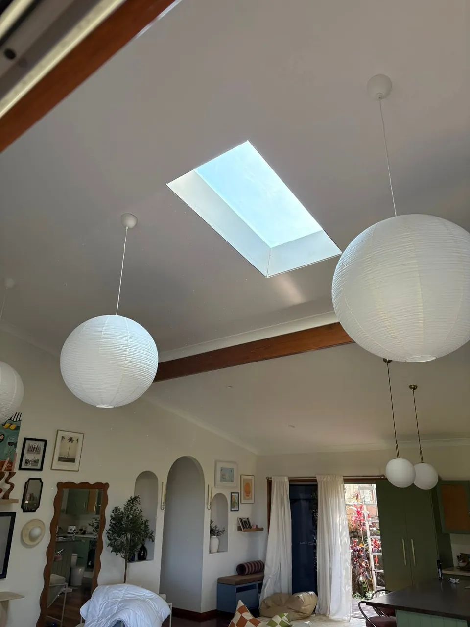 Skylight between lanterns in a raked living room ceiling