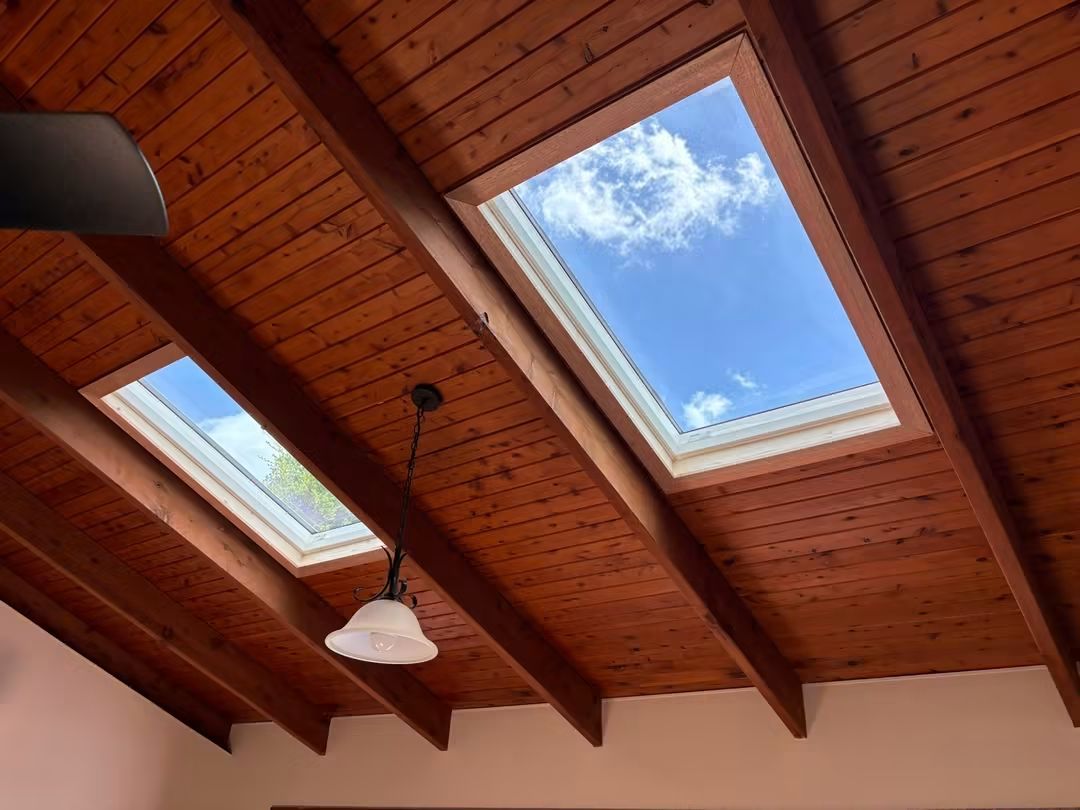 Two skylights in a timber-lined raked ceiling
