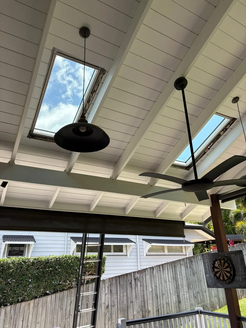Two skylights in a white raked patio ceiling