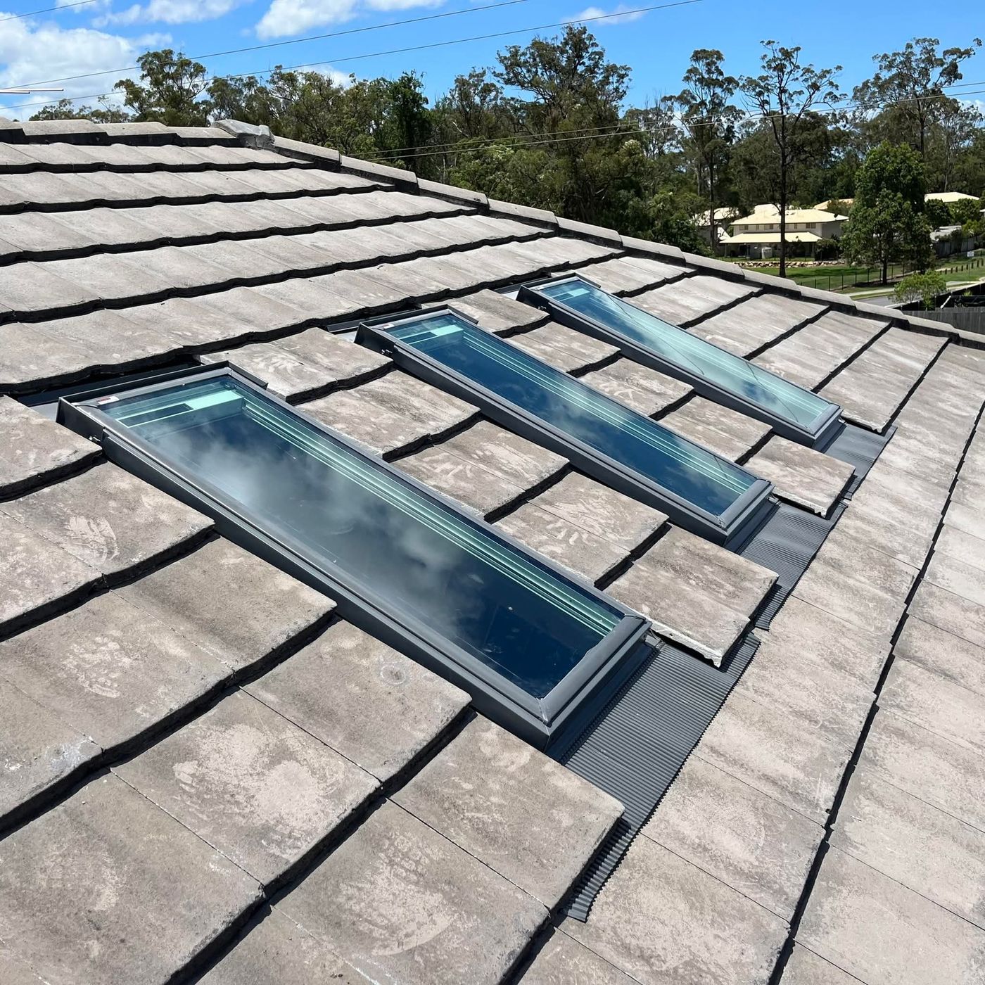 Three skylights installed in a concrete tile roof